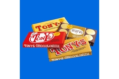 Image Assorted Tony Chocolonely chocolate bars in colorful wrappers.